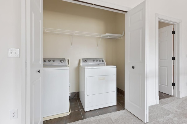 clothes washing area with laundry area, dark tile patterned floors, dark colored carpet, and independent washer and dryer