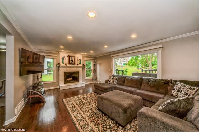 living room featuring dark wood-style floors, crown molding, recessed lighting, a premium fireplace, and baseboards