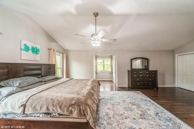 bedroom with a ceiling fan, lofted ceiling, baseboards, and wood finished floors