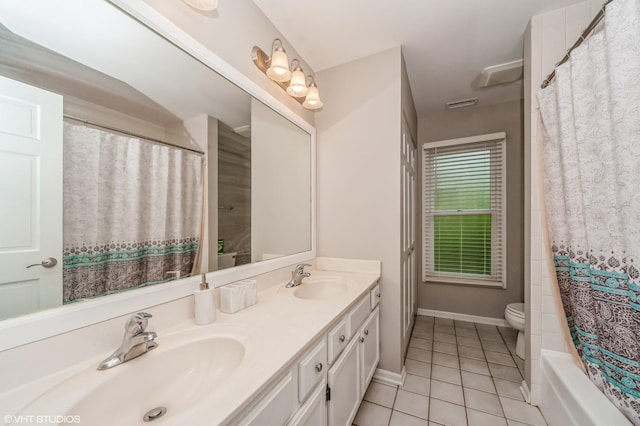 bathroom with toilet, a sink, visible vents, and tile patterned floors