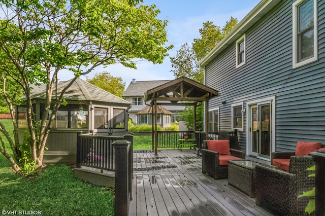 deck with a sunroom and a gazebo