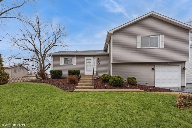 tri-level home featuring an attached garage, fence, concrete driveway, and a front yard