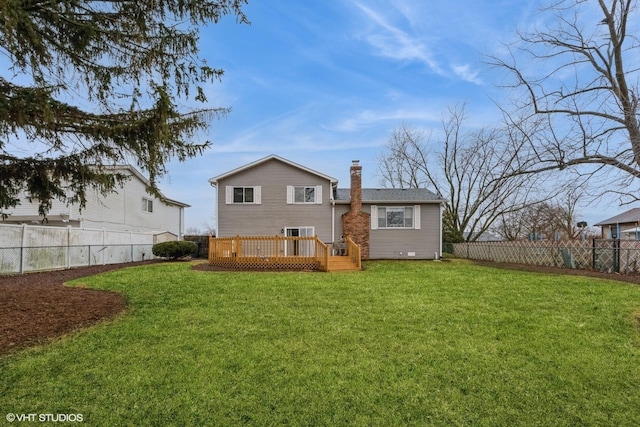 rear view of property with a fenced backyard, a chimney, a lawn, and a wooden deck