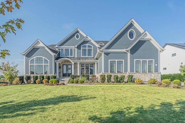 view of front of house featuring stone siding and a front lawn