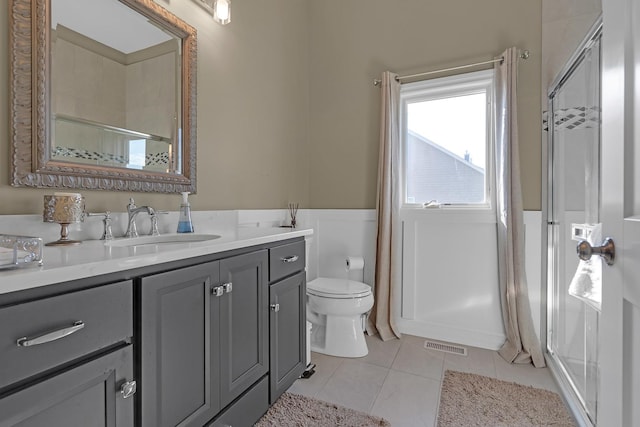 full bathroom with visible vents, toilet, a wainscoted wall, tile patterned flooring, and vanity