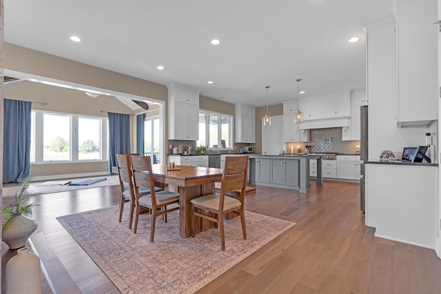 dining room with baseboards, light wood-style flooring, and recessed lighting