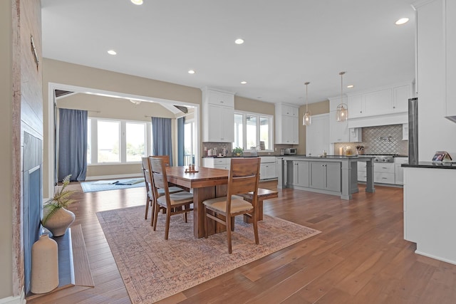 dining room with dark wood-type flooring and recessed lighting