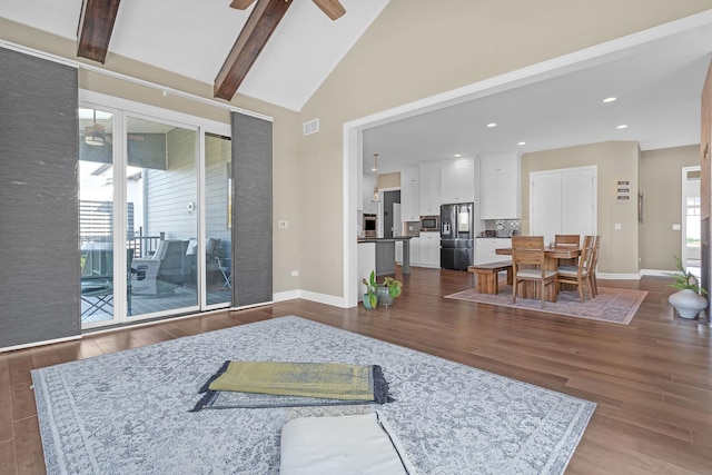 living area featuring dark wood-style flooring, plenty of natural light, and a ceiling fan