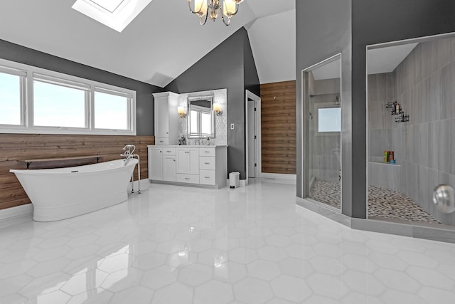 bathroom featuring wooden walls, vanity, a soaking tub, a shower stall, and lofted ceiling with skylight