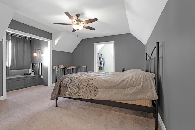 bedroom featuring a ceiling fan, light colored carpet, vaulted ceiling, and baseboards