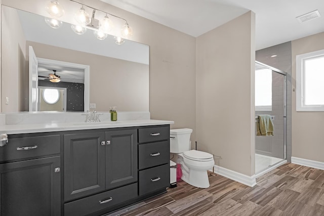 bathroom with toilet, a shower stall, visible vents, and wood tiled floor