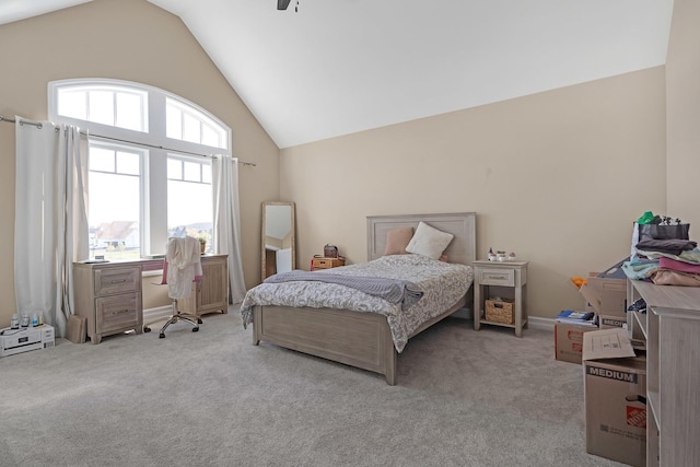 bedroom featuring carpet floors, baseboards, and high vaulted ceiling