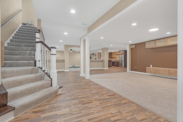 entrance foyer featuring light wood-style flooring, stairs, visible vents, and recessed lighting