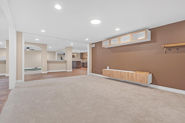 basement with recessed lighting, baseboards, and light colored carpet