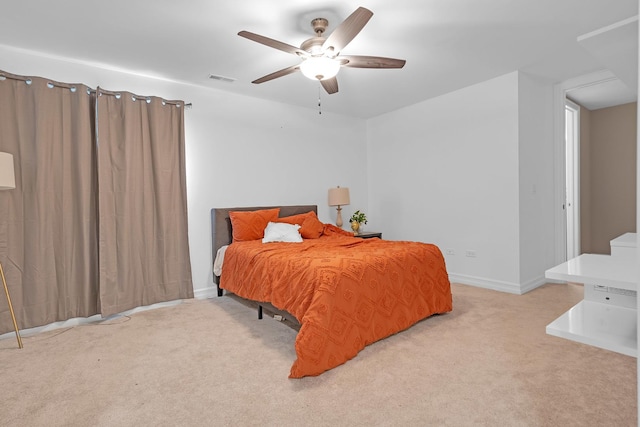 carpeted bedroom with visible vents, ceiling fan, and baseboards