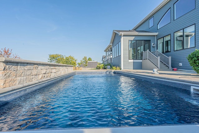 view of pool with a fenced in pool and fence