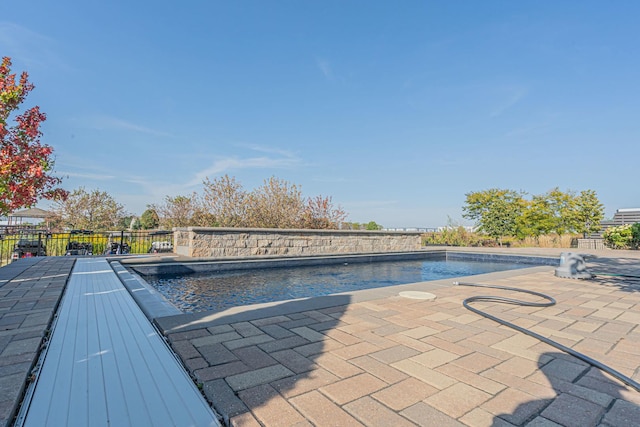 view of pool with fence, a fenced in pool, and a patio