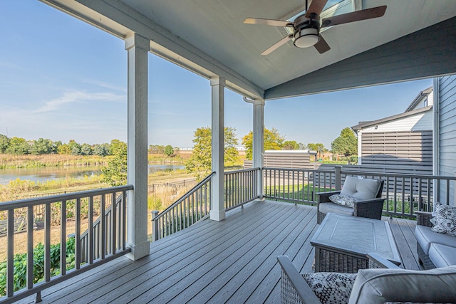 wooden terrace featuring a ceiling fan and a water view