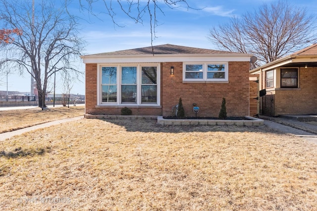 bungalow-style home featuring brick siding