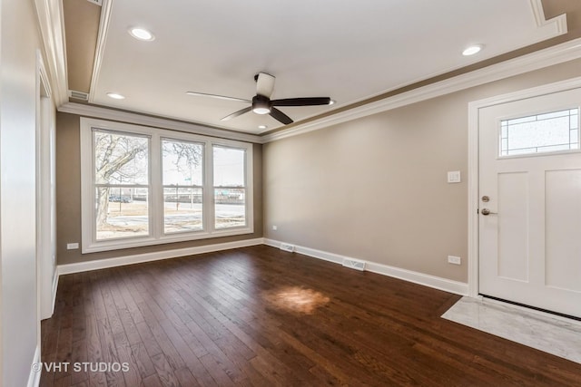 foyer featuring a healthy amount of sunlight, baseboards, crown molding, and dark wood-type flooring