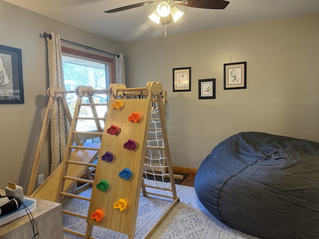 bedroom with a ceiling fan and baseboards