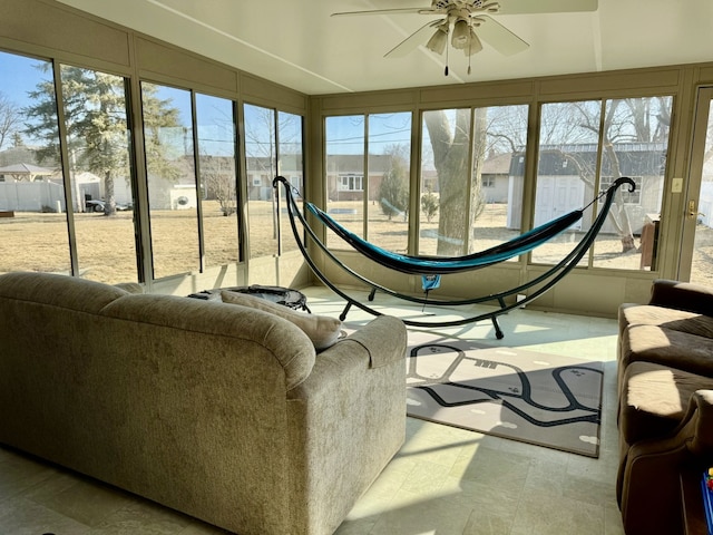 sunroom featuring a ceiling fan