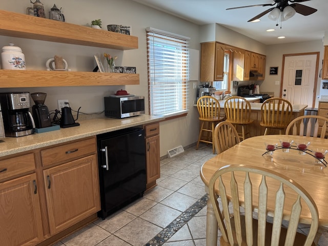 kitchen with visible vents, range, stainless steel microwave, fridge, and open shelves