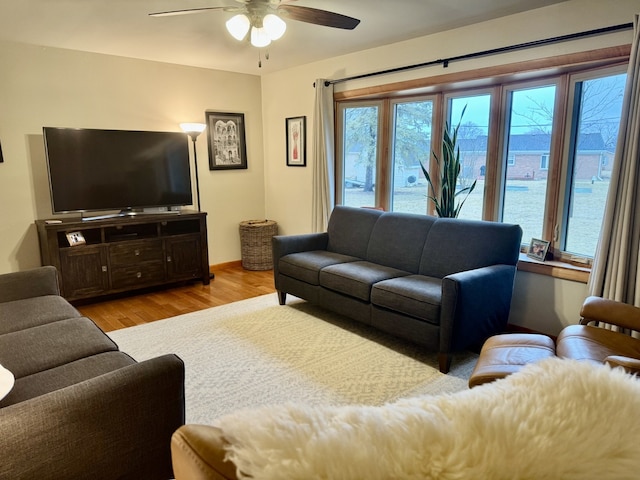 living room featuring light wood-type flooring and ceiling fan