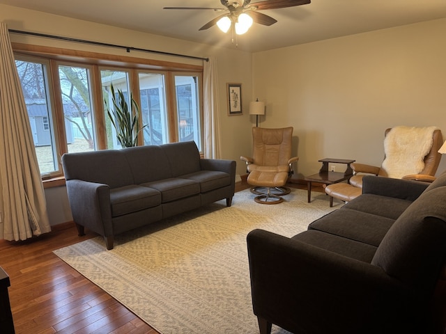 living room featuring hardwood / wood-style flooring and a ceiling fan