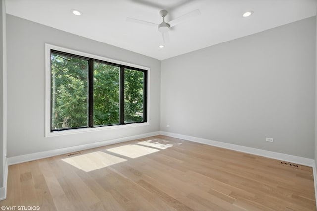 empty room featuring recessed lighting, visible vents, light wood-style flooring, and baseboards