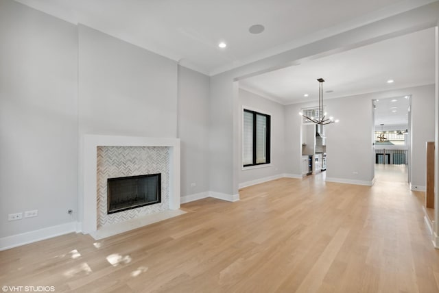 unfurnished living room featuring a tile fireplace, light wood-style flooring, and baseboards