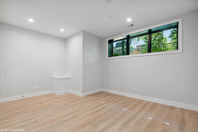 empty room featuring baseboards, recessed lighting, and light wood-style floors