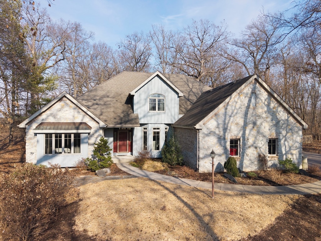 view of front of property with a shingled roof and board and batten siding