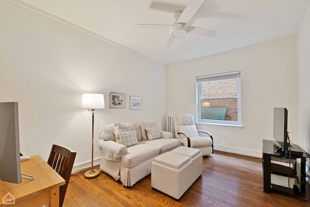 living room with ceiling fan, baseboards, wood finished floors, and crown molding