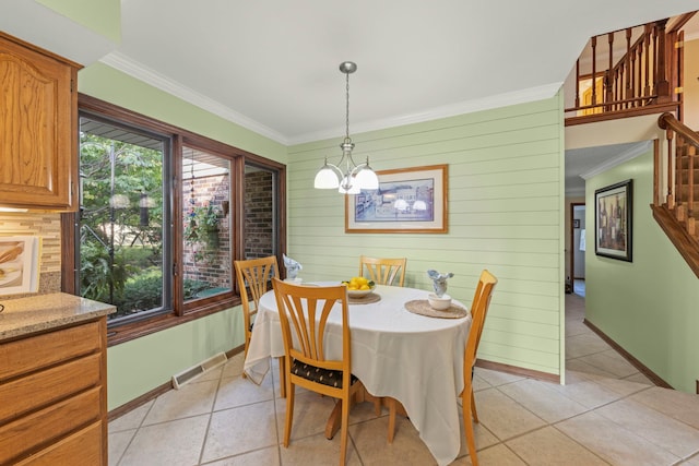 dining space featuring stairway, visible vents, ornamental molding, and a notable chandelier