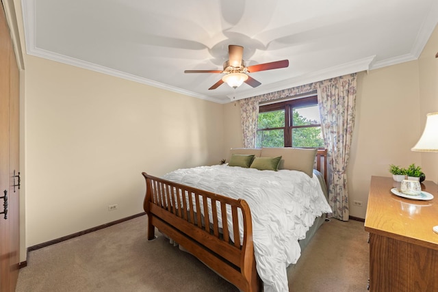 carpeted bedroom featuring baseboards, a ceiling fan, and crown molding