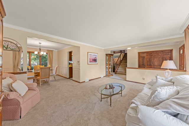 living area featuring stairs, crown molding, a notable chandelier, and light colored carpet