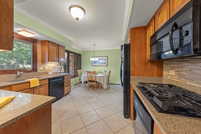 kitchen featuring brown cabinets, a sink, and black appliances