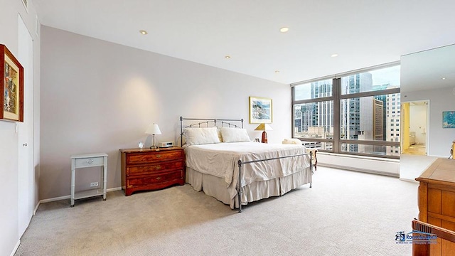 bedroom with recessed lighting and light carpet