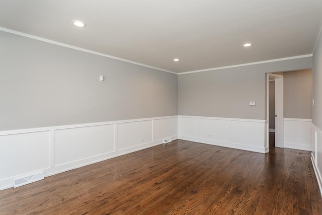 empty room with dark wood-style floors, recessed lighting, visible vents, and ornamental molding