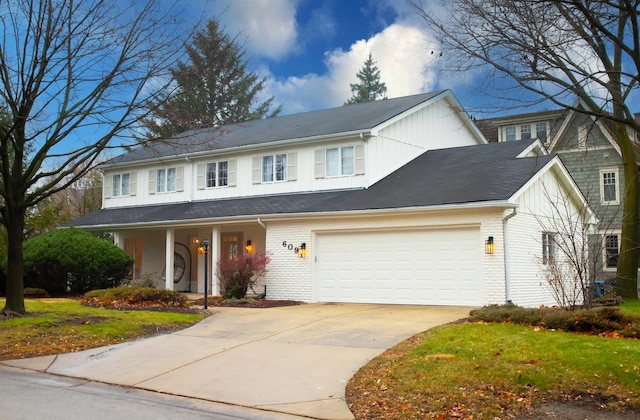 view of front facade with concrete driveway, brick siding, and an attached garage