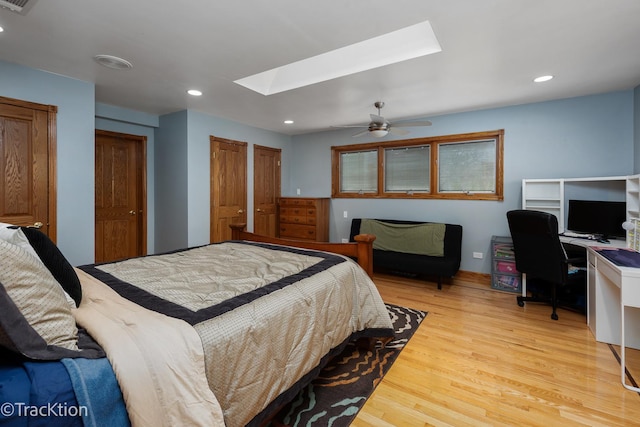 bedroom featuring recessed lighting, light wood-type flooring, a skylight, and ceiling fan