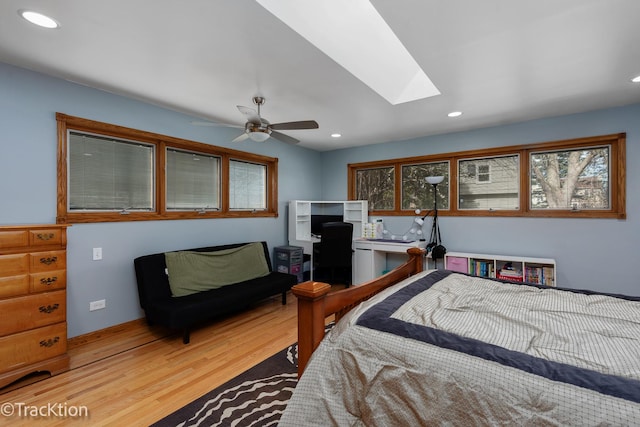 bedroom with a skylight, recessed lighting, and light wood-style flooring