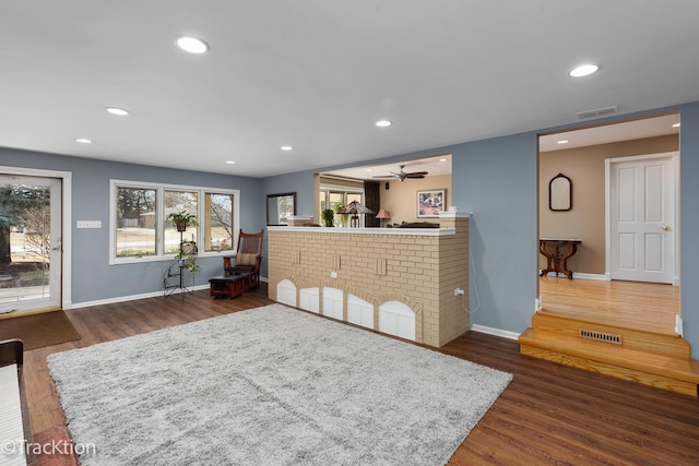 living room featuring recessed lighting, visible vents, and wood finished floors