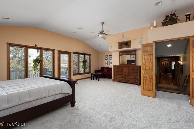 bedroom with lofted ceiling, multiple windows, light colored carpet, and visible vents