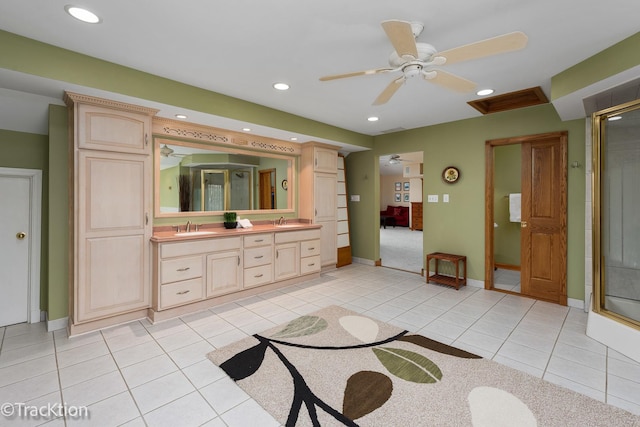 ensuite bathroom with double vanity, recessed lighting, a stall shower, a sink, and tile patterned flooring