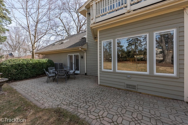 view of patio with a balcony and visible vents