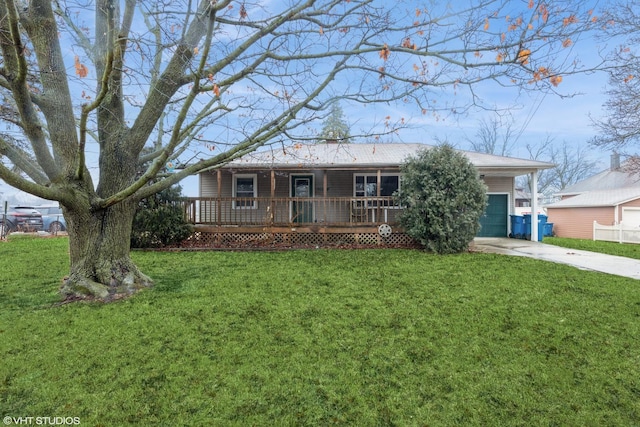 ranch-style home with covered porch, driveway, and a front yard