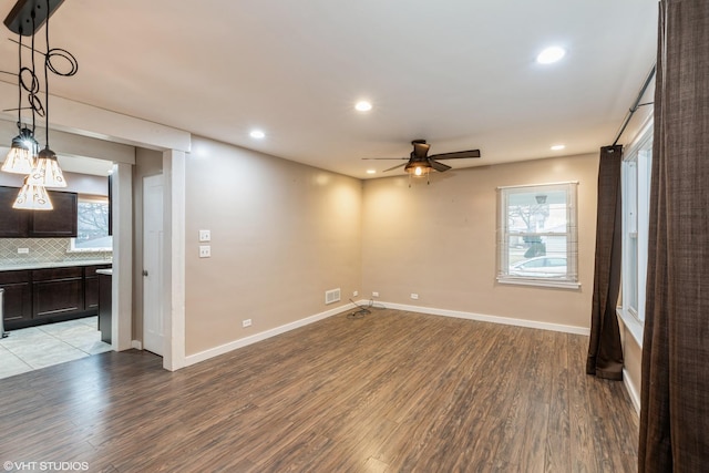 interior space featuring baseboards, light wood-style flooring, and a healthy amount of sunlight