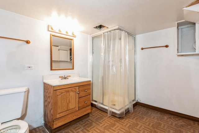 full bathroom with a stall shower, vanity, toilet, and baseboards